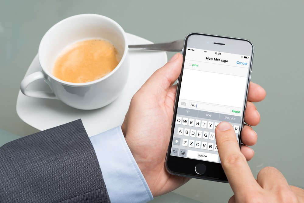 Businessman Text Messaging On Apple iPhone 6