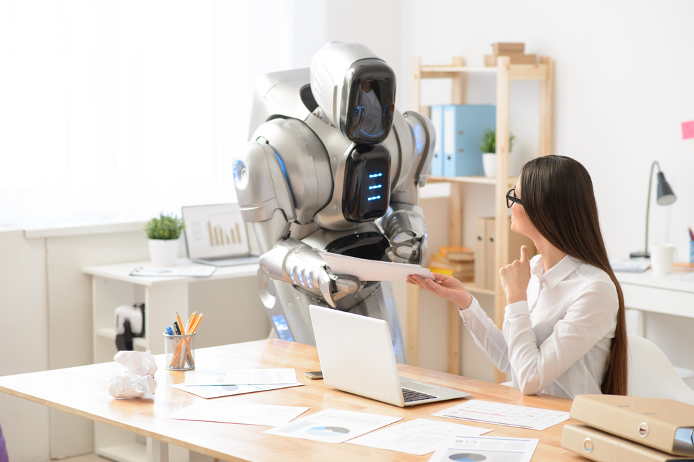 girl and robot working in the office