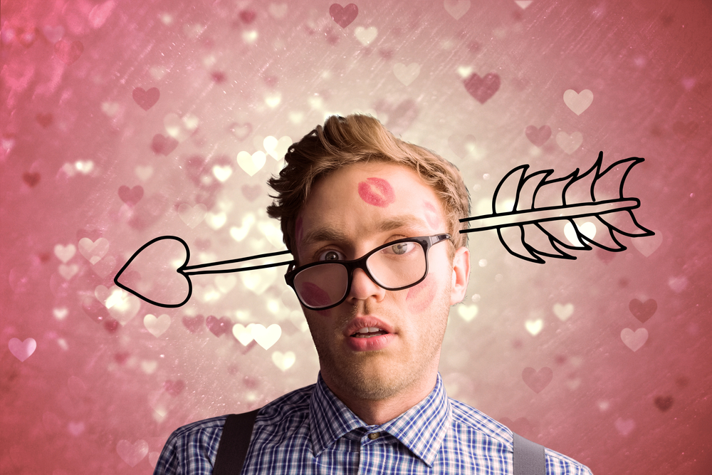 geeky-hipster-covered-in-kisses-against-valentines-heart