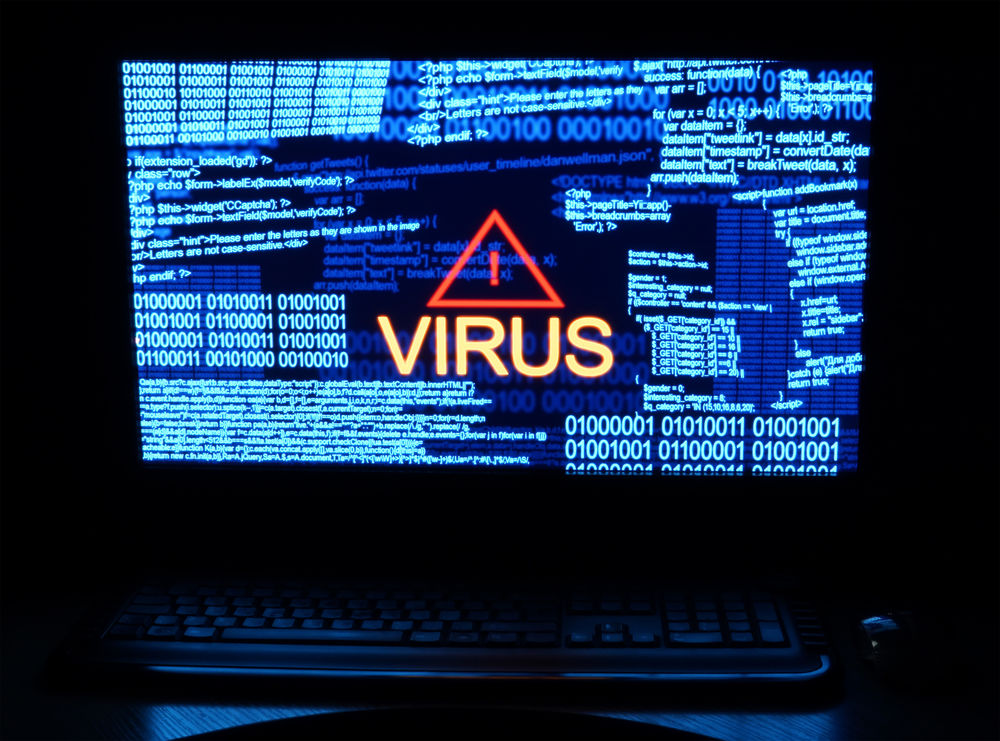 Computer-in-dark-with-word-virus