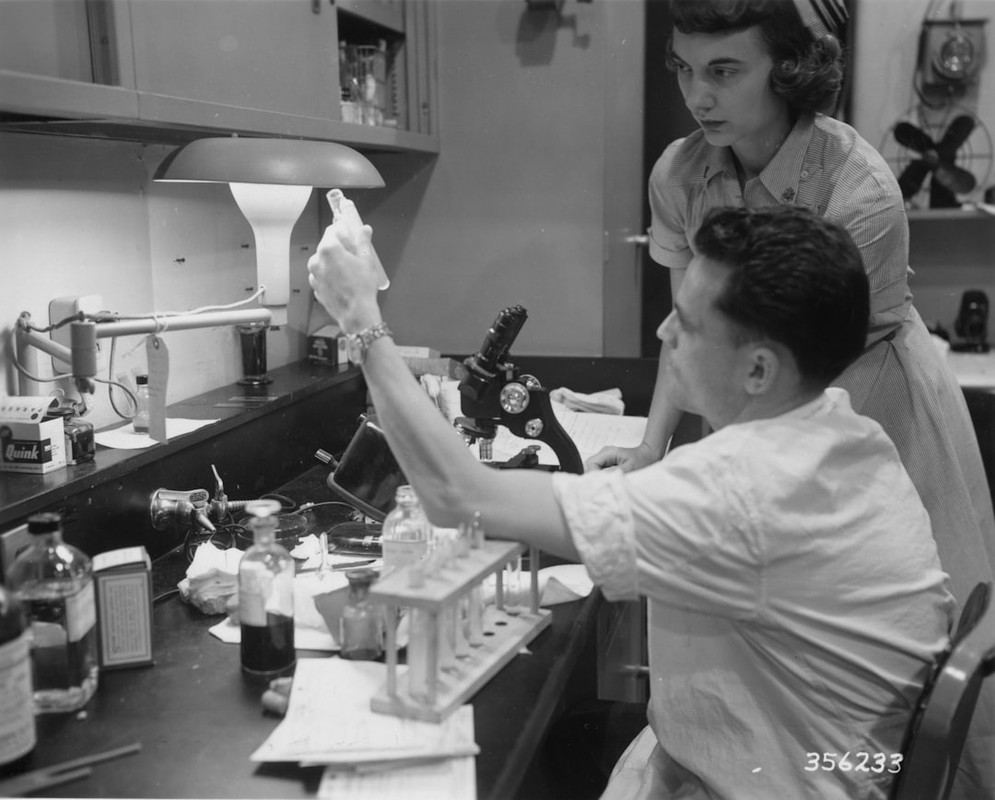 Two people working in a laboratory with equipment.