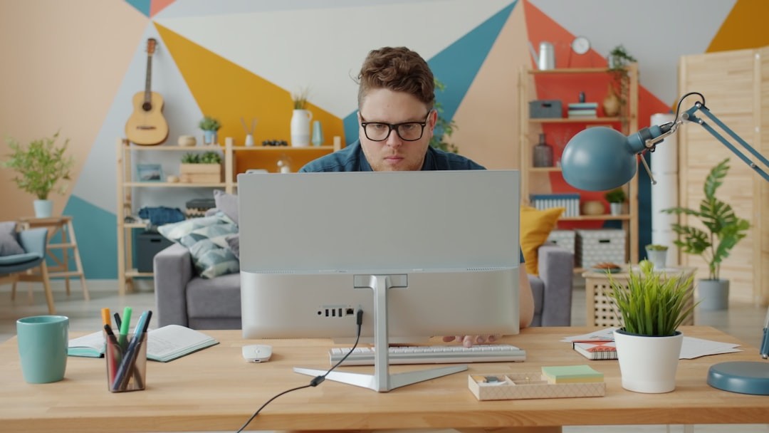 Man working on computer in colorful home office
