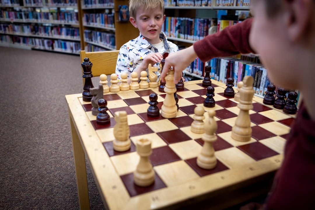 Children are playing a game of chess in a library.
