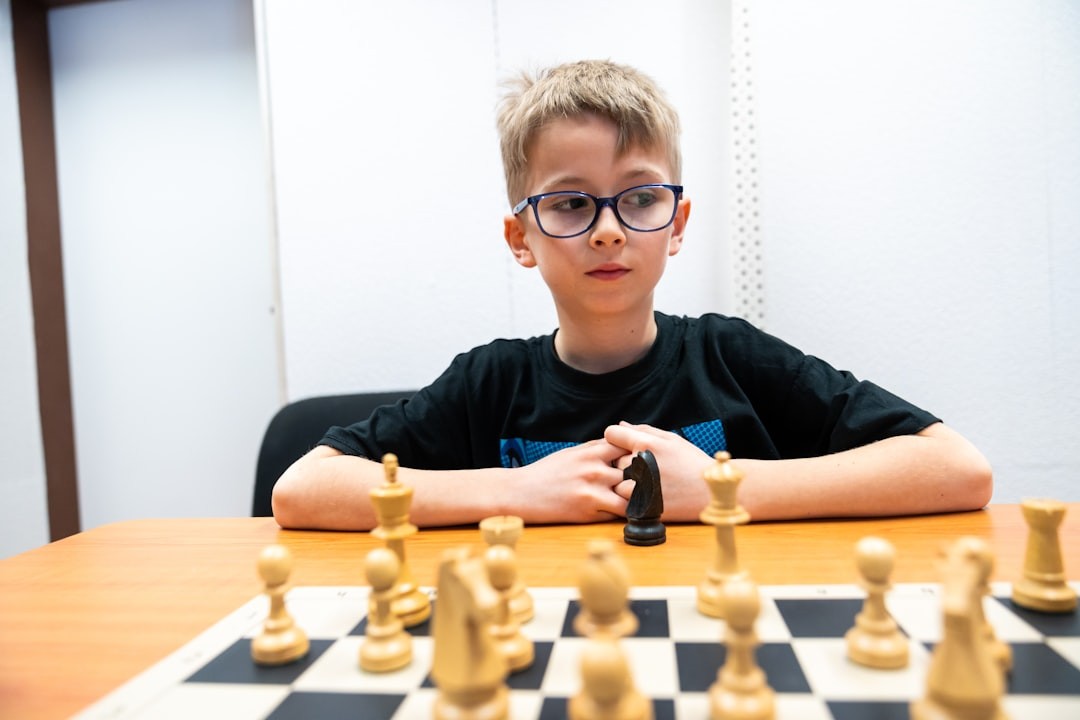 Young boy playing chess at a table