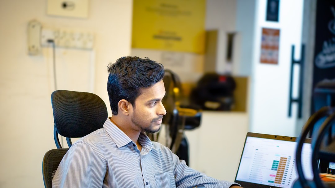 A man sitting in front of a laptop computer