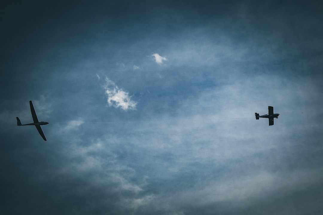 Two aircraft flying in a cloudy sky